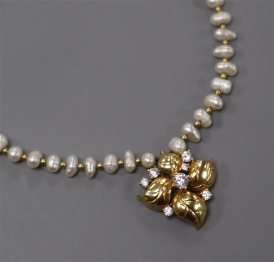 An 18k yellow metal and diamond set pendant, on a baroque cultured pearl and yellow metal spacer necklace, pendant 23mm.